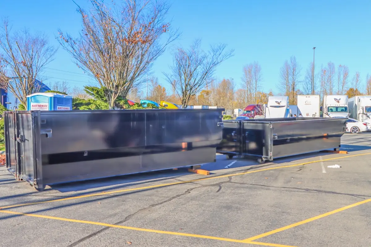 Professional dumpster rental service with roll-off container on residential driveway in Aubrey